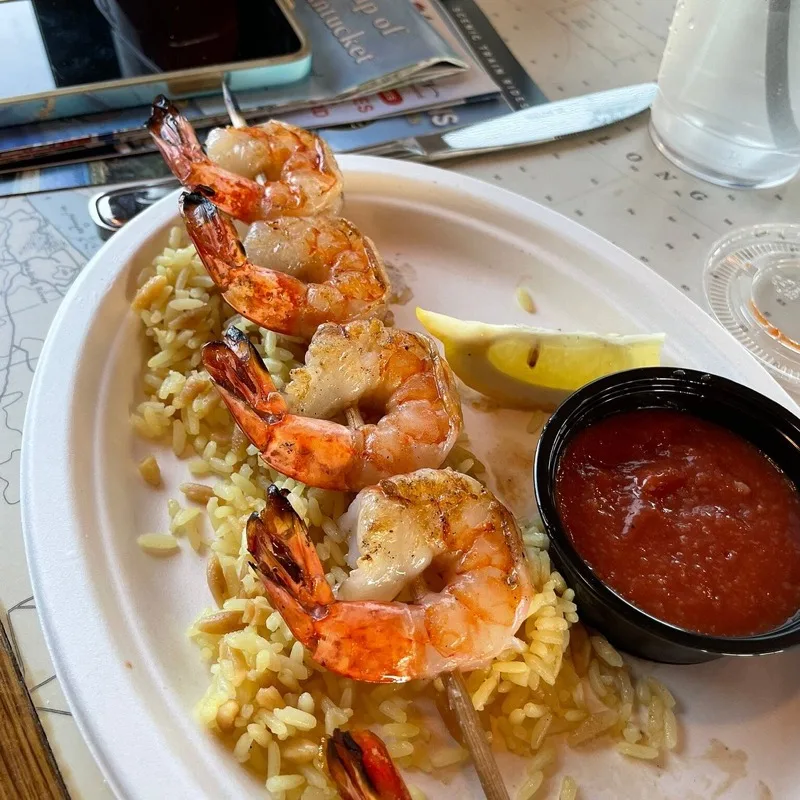 Grilled shrimp skewer on rice